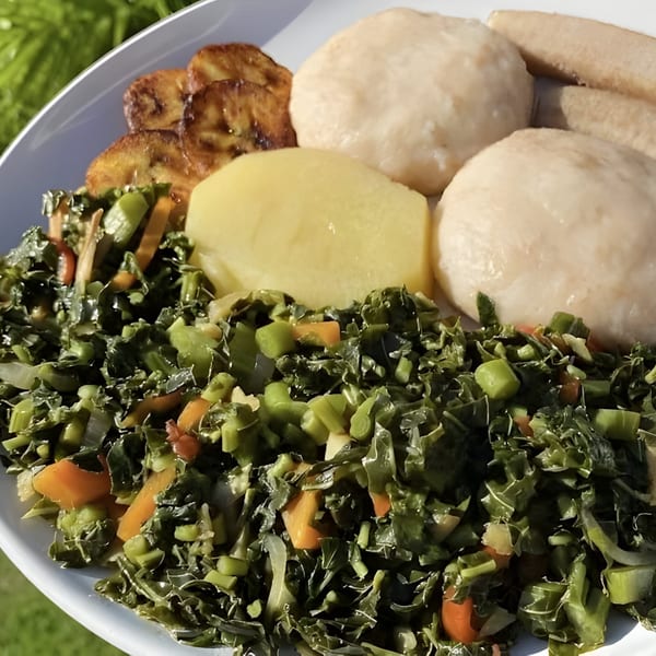 A Caribbean dish with callaloo, fried plantains, boiled dumplings, and a yellow root vegetable.